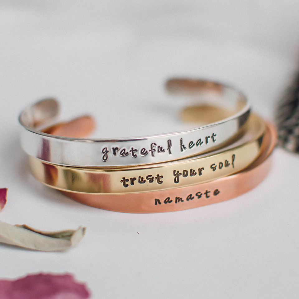 Plated brass cuffs in rhodium, gold, rose gold with antiqued letters